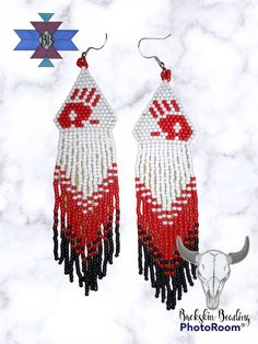 the earrings are decorated with red, white and black beads