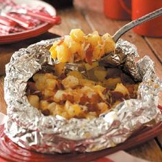 the food is covered in tin foil and ready to be eaten on the table for lunch