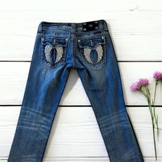 Miss Me Angel Wing Jeans 27"waist 32"inseam 7.0"rise 6.0" (12" CIRC) Ankle Miss Me Angel Wing Jeans. GORGEOUS ❤️️ Slim cut, see pic for ankle measurements. Beautiful and distressed. Baby blue coloring. Perfect to go under boots. Muted silver hardware two button closure at the waist. Great distressed wear through out. Super soft. Angel wing pockets with studded crystals off-white cream angel wings absolutely gorgeous. Rare. Hard to find style with this fit.  27"waist  32"inseam  7.0"rise  6.0" (1 Y2k Early 2000s, Find Style, Y2k Jeans, Jeans Y2k, Early 2000s, Pocket Jeans, White Cream, Miss Me, Silver Hardware