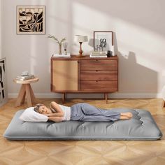 a woman is laying on an inflatable mattress with her head resting on the pillow