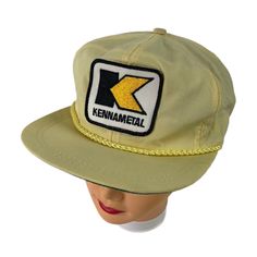 Vintage 80s Rare Kennametal K-Brand Yellow Rope Trucker Hat with Kennametal Patch - Adjustable Fit Flat Brim Cap - Made in U.S.A. This vintage item is in excellent condition with no notable signs of wear. It has been cleaned and inspected for imperfections. Fast Shipping - Orders are promptly shipped within one business day Feel free to message us with questions.