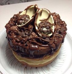 a chocolate covered cake sitting on top of a white plate