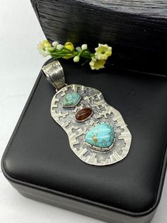 Artisan Turquoise and Mexican fire Opal pendant Hand-made Sterling Silver 925.  Stones used: Turquoise (Nevada), Mexican Fire Opal.  Height -3” (including bail), Width – 1 1/4”  Height – 75mm (including bail), Width – 35mmUnique Handcrafted One-of a-kind Design PendantEach Piece of Jewelry in my Collection is Absolutely One of a Kind!When you start wearing a piece of my jewelry you will fall in love with it more and more each day and feel that good Energy and Love that I pass into it while creat Unique Untreated Turquoise Necklace Gift, Turquoise Pendant In Sterling Silver, Turquoise Sterling Silver Pendant Gemstone, Unique Untreated Turquoise Necklace As Gift, Turquoise Pendant Gemstone In Sterling Silver, Unique Untreated Turquoise Necklace For Gift, Southwestern Pendant Jewelry As Gift, Southwestern Pendant Jewelry Gift, Southwestern Pendant Jewelry As A Gift