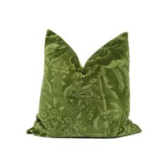 a green pillow with a floral design on it