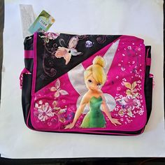 Disney Tinkerbell Messenger Bag, School Bag. Can Be Used As Diaper Bag Or Overnight Bag. Brand New With Tags. Disney Fairies Collection. Features Floral Butterfly Design, Tinkerbells Wings Are Iridescent Material. Measures 16" Length X 4" Width X 13" Height Flap Velcro Closure Two Zippered Compartments Inside Ruffled Side Pockets With Velcro Adjustable Strap Women Teens Girls 90s 2000s Girly School Camp Mall Nwt Brandnew Spring Summer Flowers Butterflies #Disneybags #Messengerbags #Tinkerbell #F Messenger Bag School, Fairies Tinkerbell, Kids Rolling Backpack, Messenger Bags For School, Mickey Mouse Bag, Disney Storybook, Disney Necklace, School Camp, Jojo Bows