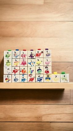 a wooden shelf filled with lots of colorful blocks