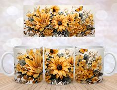 three coffee mugs with sunflowers and butterflies painted on them, sitting on a wooden table