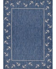 a blue rug with anchors on it and an area rug in the middle that has white trim