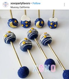 blue and white cake pops with gold stars on them