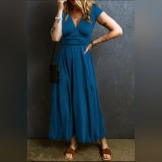 This Long Dress Is Suitable For Different Occasions. A Trendy High Waist Look With Shirred Details At The Back. It Has A Sexy V-Neck, Short Sleeves And A Flared Maxi Length Blue V-neck Maxi Dress For Date Night, Blue V-neck Maxi Dress For Night Out, Blue Non-stretch Dress For Night Out, Non-stretch Blue Dress For Night Out, Blue Solid Color Maxi Dress For Party, Blue Solid Color Evening Midi Dress, Blue Non-stretch Midi Dress With V-neck, Blue V-neck Midi Dress Solid Color, Blue V-neck Solid Color Dress