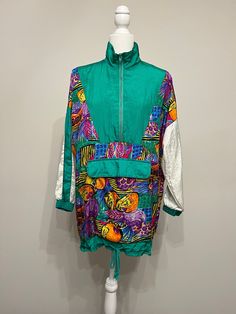 "Oh wow This jacket is 80s fabulous!  It is by Avait Sport, sometime mid 80s to early 90s.  It has a bold kelly green as its predominant color and a rainbow of other bright colors in a fruit pattern.  This jacket definitely makes a statement!  It's baggy and oversized in a size Small.  Please see measurements below.  You may want to size down depending upon how you want it to fit.  It has a drawstring bottom and hangs longer than some of the other track jackets from this era that have banded bottoms.  I just love this jacket I love when an item represents its era so well.  The jacket is in excellent condition!  It's 100% nylon fabric.  It's vintage fabulous!  Thanks for looking! Measurements taken laying flat: please double for chest & waist Armpit to armpit 24\" Waist/middle 23\" Sleeves Oversized Green Windbreaker For Spring, Green Oversized Windbreaker For Spring, Green Nylon Windbreaker For Fall, Green Patchwork Long Sleeve Track Jacket, Green Long Sleeve Patchwork Track Jacket, Fall Green Nylon Windbreaker, Spring Outdoor Patchwork Windbreaker, Trendy Patchwork Windbreaker For Streetwear, Patchwork Nylon Windbreaker For Spring