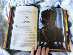 a person reading a book on top of a bed