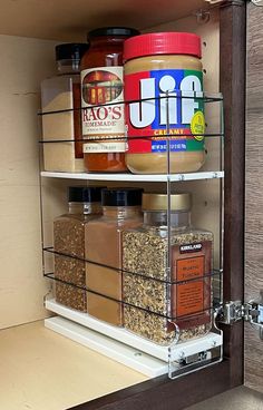 an open cabinet with spices and seasonings in it