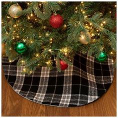 a christmas tree skirt with ornaments on it