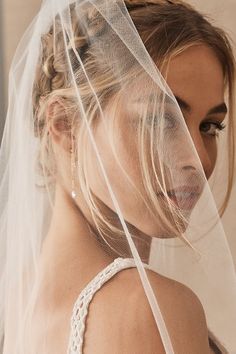 a woman wearing a veil with her hair pulled back