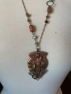 "Assemblage Jewelry This Neo-Victorian assemblage necklace is made mainly with wonderful vintage copper findings and the chain has a few sparkly beads for pizzaz. A truly lovely piece. Chain 12\" down each side pendant 3\"x1.5\" hangs a total 15\" Many of my necklaces have chains that can be adjusted for length. Just message me and ask. If it's possible, I'm happy to do so. Oh, please note that things really do look better in person, at least according to all the feedback I've had in the past!   PLEASE BE SURE TO READ ALL INFORMATION & POLICIES BELOW BEFORE ORDERING  I will combine shipping for the lowest cost. OOAK. Eclectic. Unique. Hand made jewelry & clothing made from vintage & new materials repurposed into Boho Chic, Victorian/Neo-Victorian, & Steampunk styles. Wearable Art for those Artisan Vintage Charm Necklaces, Artisan Necklaces With Vintage Charm, Antique Gold Beaded Vintage Necklace, Vintage Beaded Antique Gold Necklace, Vintage Copper Medallion Necklace, Bronze Bohemian Necklace With Vintage Charm, Bohemian Metal Necklaces With Patina, Bohemian Bronze Necklace With Vintage Charm, Bronze Steampunk Necklaces For Jewelry Making