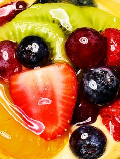 some fruit is sitting in a bowl with liquid on the top and around it's edges