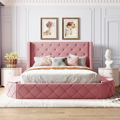 a pink bed with white sheets and pillows in a room that is painted pale colors