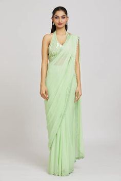 Light green georgette pre-draped saree with an embroidered border. Paired with a padded silk blouse with sequin, bead and mirror embroidery and detacheable belt.
Components: 3
Pattern: Embroidered
Type Of Work: Sequin, Bead, Mirror
Neckline: Halter
Sleeve Type: Sleeveless
Fabric: Silk, Georgette, Organza
Color: Green
Other Details: 
Attached lining
Approx. product weight: 2-3 kgs
Note: The fabric is silk blend and not pure silk
Occasion: Mehendi and Haldi - Aza Fashions Bead Mirror, Draped Saree, Mirror Embroidery, Border Saree, Sequin Halter, Drape Saree, Embroidered Border, Blouse For Women, Saree With Blouse