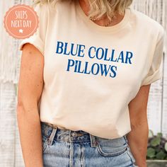 If you're looking for a thoughtful and practical gift, our apparel is sure to be appreciated by anyone who receives it. These blue collar tshirts are handmade to order on an ultra-soft shirt that will quickly become your go-to apparel item! Our trendy cowboy pillows tees are made with eco-friendly water-based ink that feels good and lasts longer! You will never want to take it off! ♥Sizing info♥ *Unisex sizing. *Order your true size for a more fitted feel. Size up for a slouchier look ♥Care Instructions♥ *Wash on cold *Hang dry or tumble dry on low heat *Non-chlorine bleach only *Do not iron directly on the design ♥Shipping♥ 🚚Every order (no matter how large) ships same or next business day! We want you to receive your garment as quickly as you can so you can start enjoying it! 📦Free shi Blue Cotton Slogan Top, Blue Tops With Letter Print And Comfortable Fit, Blue Letter Print Top With Comfortable Fit, Comfortable Blue Letter Print Top, Casual Blue Ring-spun Cotton Top, Cotton Tops With Funny Text For Fan Merchandise, Cotton Top With Funny Text For Fan Merchandise, Blue Graphic Tee With Funny Text, Blue Short Sleeve Ring-spun Cotton Top