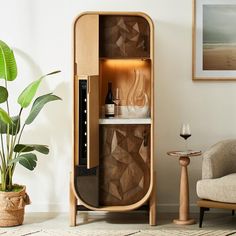 a wooden cabinet sitting next to a potted plant