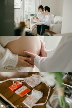 a pregnant woman holding her belly while sitting on a bed next to a man in a white shirt