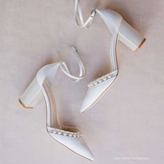 white high heeled shoes with pearls on the toes