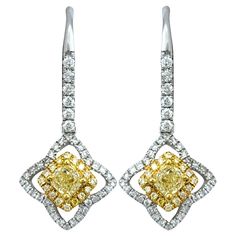 This stunning pair of Canary Star yellow and white diamond dangle earrings are exquisitely set in 18 karat yellow and white gold. These captivating earrings feature a dazzling array of diamonds, artfully arranged to create a radiant display of sparkle and color. The blend of yellow and white gold enhances the brilliance of the coordinating colored diamonds, while the elegant dangle design adds movement and sophistication. Perfect for special occasions or adding a touch of luxury to any outfit, these earrings combine exceptional craftsmanship with timeless beauty, making them a cherished addition to any fine jewelry collection. This piece is in very good estate condition and has been professionally cleaned and polished. It comes with an appraisal card, verifying its authenticity and current White Diamond Dangle Earrings, Diamond Dangle Earrings, Fine Jewelry Collection, Diamond Clarity, White Diamond, Timeless Beauty, Colored Diamonds, Two Tone, Diamond Cuts