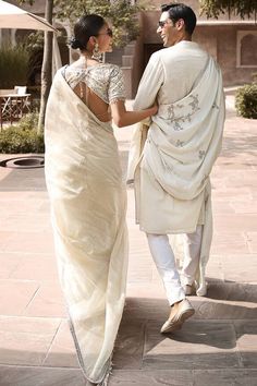 Ivory tissue blouse with celestial inspired moon motifs, Mughal jaal pattern and rustic zardozi pittan hand embroidery. Paired with striped wrinkled saree with hand work border. - Aza Fashions Reception Blouse With Chikankari Embroidery In Traditional Drape, Wedding Blouse With Chikankari Embroidery For Eid, Traditional Cotton Silk Blouse With Intricate Embroidery, Navratri Raw Silk Pre-draped Saree With Chikankari Embroidery, Chikankari Embroidery Chanderi Blouse For Reception, Traditional Pre-draped Off White Saree, Elegant Pre-draped Saree With Chikankari Embroidery, Reception Blouse Piece With Chikankari Embroidery, Wedding Blouse With Chikankari Embroidery For Transitional Season