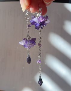 Wisteria amethyst earrings These wisteria earrings feature purple glass flowers and many amethyst crystals. Let's keep wisteria blooming! Available in silver finish! Also can make in gold.  * S I Z E  - Length: 90mm(without hook) - Width: 12mm Purple Crystal Jewelry, Unique Purple Flower Earrings, Dainty Dangle Jewelry For Mother's Day, Purple Dangle Flower Earrings, Lavender Earrings With Natural Stones For Gift, Flower Shaped Sterling Silver Jewelry With Natural Stones, Sterling Silver Flower Jewelry With Natural Stones, Lavender Amethyst Earrings With Natural Stones, Handmade Purple Crystal Drop Earrings