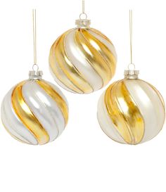 three gold and white ornaments hanging from strings