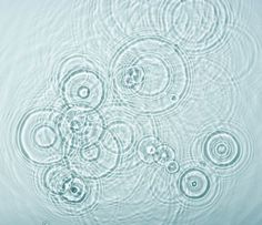 water ripples on the surface of a pool with circles and bubbles floating in it