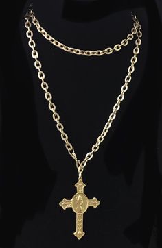 Our Matte Gold Cross of Saint Benedict (aka San Benito) is a sacramental holy medal that has been believed to repel evil for centuries. It hangs on a 34" etched cable chain with a shepherds hook that allows it to be worn an unlimited number of ways because the hook can be fastened on any of the cable links. You can wear it doubled and short of mid length as a lariat or as a long layering piece with your other Whispering Goddess necklaces. The cross itself is timeless and according to the Benedic Spiritual Crucifix Charm Necklace, Spiritual Charms Necklaces For Commemoration, Spiritual Hallmarked Crucifix Necklace, Spiritual Necklace With Miraculous Medal For Commemoration, Bronze Crucifix Necklace For Spiritual Purposes, Spiritual Bronze Crucifix Necklace, Antique Cross Necklaces For Collectibles, Miraculous Medal Pendant Necklace For Memorials, Miraculous Medal Pendant Necklace For Memorial