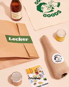 an assortment of food and drink items on a table with a paper bag, napkins, stickers