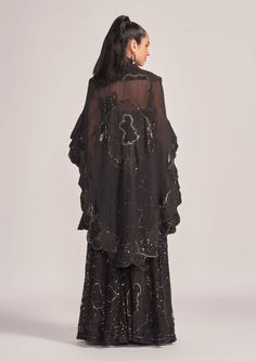 The Zarya black cape, blouse, and palazzo set exudes elegance and sophistication. With a flowing cape, a stylish blouse, and wide-legged palazzo pants, this ensemble is perfect for formal occasions, making a bold fashion statement.