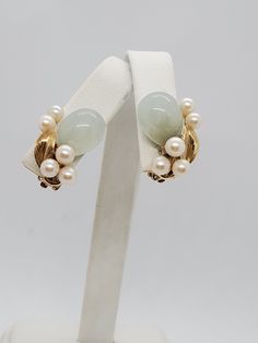 You are viewing a beautiful ming's 14k solid gold jade and white pearl clip earrings. Each earrings measures approx.21mm x 15mm The total gram weight of the earrings is approx.10.41 grams The earrings marked ming's and 14k. The earrings is clip on style and in good condition. This earrings has matching brooch ( see on my other listing) Ready to wear. Send me a message if you have a question. 14k Gold Clip-on Earrings For Wedding, Stunning Necklace, Clip Earrings, Flower Pendant, Pearl Ring, White Pearl, Earring Gifts, Pearl White, Ring Gift