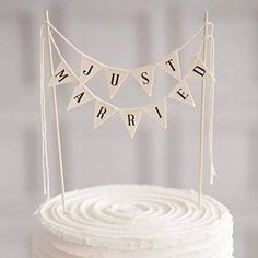 a white cake topped with a bunting banner