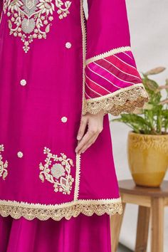 Magenta pink kurta with floral motif gota hand work and bell sleeves. Comes with gharara pants and scallop border dupatta.
Components:3
Embroidered
Neckline:Round
Sleeve Length:Full
Fabric:Silk
Color:Pink
Bell sleeves
Striped panels
Back keyhole
Elastic waistband
Scallop lace trim dupatta - Aza Fashions Gharara Pants, Pink Kurta, Scallop Border, Silk Kurta, Embroidered Neckline, Magenta Pink, Fabric Silk, Hand Work, Scalloped Lace