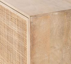 a close up of a wooden table with wicker covering it's sides and the top