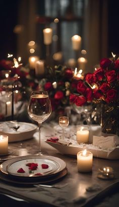 the table is set with candles, plates and wine glasses for dinner guests to enjoy