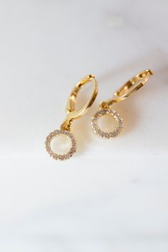 Our Myla Dainty O-Ring Huggie Earrings are the perfect minimalist earrings! Made with a crystal beaded gold filled O-Ring attached to a gold filled huggie hoop. These simple earrings are a beautiful staple piece! Gold Halo Design Dangle Jewelry, Gold Dangle Jewelry With Halo Design, Gold Dangle Earrings With Halo Design, Gold Dangle Hoop Earrings With Halo Design, Everyday Gold Crystal Earrings, Dainty 14k Gold Earrings With Sparkling Stones, Gold Drop Earrings For Everyday, Minimalist Gold Crystal Earrings, Gold Minimalist Crystal Earrings