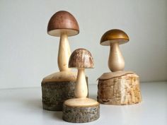 three wooden mushrooms sitting on top of each other