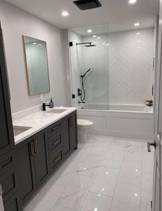 a large bathroom with two sinks and a shower