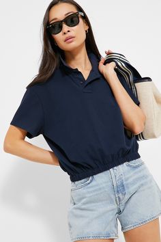 We can't stop talking about the Navy Collins Polo- and for good reason! This classic style staple includes a collar, partial front button placket, and and elastic waistband that gives you a clean, cinched in look without the fuss of tucking in your shirt. Pair with wide leg trousers and loafers for work, or with denim shorts and sneakers for weekend play. Collar Short sleeves Front two button placket Relaxed fit Elastic waistband Material: 65% Cotton, 35% Polyester Care: Hand wash cold, hang to Everyday Relaxed Fit Top With Elastic Waistband, Casual Johnny Collar Tops For Daywear, Casual Tops With Johnny Collar For Daywear, Relaxed Fit Tops With Elastic Waistband For Work, Versatile Collared Tops For Casual Wear, Versatile Collared Tops For Casual Gatherings, Casual Navy Tops For Day, Casual Navy Top For Daywear, Casual Tops With Elastic Waistband For Daywear