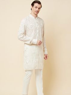 This Lucknowi kurta will instantly give an elegant look. Made from polyester cotton fabric, this 2 piece kurta set features a white lucknowi kurta, front buttons fastening, designer cuff buttons, and a mandarin collar. This lucknowi kurta has beautiful chikankari embroidery work all over. It is paired with white churidar pants. An ideal outfit for traditional & special events.

Size Chart For Men





	
	
					Men's Size Chart
		

		
		
						
				Size Chart For Men
				Custom Size Measurement G White Kurta With Naqshi For Eid, Traditional Chikankari Embroidered Kurta For Semi-formal Occasions, White Kurta For Eid Semi-formal, White Kurta For Semi-formal Festive Occasions, Off White Straight Kurta For Formal Occasions, Semi-formal Straight Kurta With Resham Embroidery, Semi-formal Long Sleeve Kurta With Chikankari Embroidery, White Semi-formal Kurta For Festive Occasions, White Semi-formal Festive Kurta