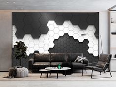 a modern living room with black and white hexagon tiles on the wall, leather sofas and coffee table