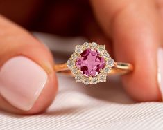 "Genuine Pink Tourmaline Halo Diamond Ring, 14k Gold Gemstone Jewelry, Wedding Engagement Promise Ring, Pink Gemstone Ring, Gift For Daughter ★ ★ ★ ★  CUSTOM/DUTY-FREE SHIPPING WORLDWIDE, BUYERS DON'T HAVE TO PAY ANY CUSTOM FEES WHILE IMPORTING ★ ★ ★ ★  Details Made to order Material: 14k/18k Gold Color Options: Yellow Gold, White Gold, Rose Gold,  ★ Center Stone:  Pink Tourmaline, Cushion Size: 6 mm Approx Weight (Ct): 0.96 ★ Accent Stones:  Diamond Round Size: 2 mm * 6 Nos, 1.5 mm * 8 Nos Appr Pink Gemstone Ring, Pink Gemstones Ring, Pink Tourmaline Ring, Natural Gemstone Jewelry, 18k Gold Ring, Gift For Daughter, Tourmaline Ring, Pink Gemstones, Halo Diamond Ring