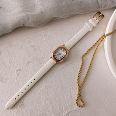 Technical specifications: ➡ Movement: Quartz ➡ Case Material: Gold colour metal ➡ Dial : White ➡ Bracelet: White Leather Strap ➡ Case Shape: Oval ➡ Case Diamensions: 18*25 mm ➡ Band Width: 10 mm ➡ Display: Analog ✈ Free Shipping Elevate your style with this exquisite women's watch, a perfect combination of gold elegance and minimalist design. Crafted for the modern woman, this dainty timepiece features a luxurious rose gold case and a smooth white leather strap, offering both comfort and sophist Small Dainty Watch, White Metal Watch For Gift, White Metal Watch As Gift, White Metal Watches With Metal Dial, White Metal Watch With Metal Dial, White Watches With Leather Strap For Gifts, Gift White Watches With Leather Strap, White Watches With Leather Strap As Gift, White Watch Accessories With Metal Dial For Gift