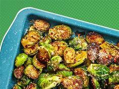 roasted brussel sprouts with parmesan cheese in a blue casserole dish