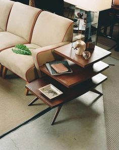 a living room with a couch, table and lamp in it's centerpiece